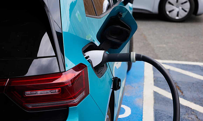 A blue electric car being charged.